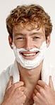 Shaving cream, happy and face of man in studio for grooming, facial maintenance or epilation routine. Smile, foam and portrait of person from Australia with hair removal treatment by white background