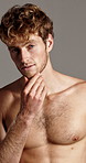 Beard, face and grooming with shirtless man in studio for masculine beauty, hygiene or skincare. Body, health and wellness with confident muscular model on gray background for change or fitness