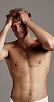 Face, hair and smile of shirtless man in studio for masculine grooming, hygiene or skincare. Body, fitness and health with happy muscular model on gray background for transformation or wellness