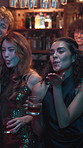 Face, smile and toast with girls in bar together for celebration, drinking or excitement at night. Alcohol, new year and party with happy woman friends in pub for cheers, clubbing or evening event