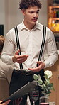 Waiter, menu and talking with man in restaurant for discussion, dinner option and hospitality. Food service, fine dining and server with people at table for cuisine, customer experience and order