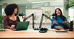 Creative, women and host with mic for content creation, interview and live streaming podcast on web. Happy, people and laughing with guest in studio, conversation and podcaster with laptop for audio