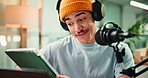 Presenter, headphones or man on mic with tablet for reading news, radio broadcast or announcement. Live streaming, host or speaking in studio for media relations, on air update or audience engagement
