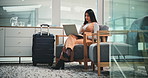 Laptop, journey and business woman in airport lounge for typing email, booking info and trip. Computer, luggage and person in waiting for flight, immigration and check departure schedule for travel