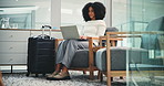 Laptop, travel and business woman in airport lounge for typing email, booking info or drink water. Computer, luggage and person in waiting for flight, immigration or check departure schedule for trip