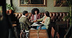 Handshake, creativity and business people in restaurant, partnership and writer with contract agreement. Publisher, group and employees in cafe, shaking hands and deal for manuscript or collaboration