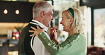 Senior, happy couple and dancing with love in home for christmas celebration or december holiday. Elderly, man and woman with smile, spin or twirl in joy for romance, festive or retirement in house