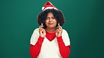 Woman, Christmas and wish in studio with fingers crossed for hope, good luck and prayer. Girl, eyes closed and emoji for excited, winning and miracle or faith on green background with optimism 