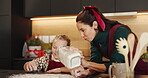 Christmas, baking and child help mother in home kitchen to flour surface and learn. Bonding, tradition and family house to teach kid to bake homemade treats to celebrate a Christian holiday with love
