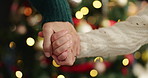 Xmas, holding hands and mother with girl, parent and bonding together with holiday season. Closeup, bokeh and mama with daughter, Christmas and festive with tradition, celebration or home decoration