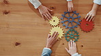 Above, hands and business people with gears for team building, solution and support. Collaboration, employees or solidarity with sign, symbol and problem solving with puzzle innovation in office
