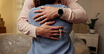 Couple, hands and hug with keys in new house for real estate purchase, mortgage success or moving in. Homeowners, people and embrace in first home for property celebration, relocation and achievement