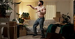 Moving in, excited and man with dancing in new home for real estate success, relocation and night. Evening energy, person and celebration in house with freedom, mortgage goals and property investment