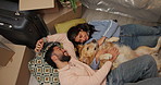 Moving in, couple and playing with dog in new home for security, mortgage purchase and goals. Above, people and excited with animal on floor for property investment, achievement and bonding together