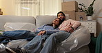 Sleep, tired and couple on sofa in new home with boxes, hug and mortgage with dog. Relax, pet and exhausted people resting in house with romantic embrace, love and fatigue with property investment