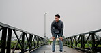 Runner, man and tired with fitness on bridge for marathon burnout, breathing and running break. Cardio fatigue, athlete and exhausted outdoor for race performance, endurance challenge and overworked