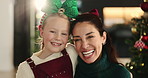 Happy girl, face and mother with hug for christmas celebration or festive holiday together in home. Portrait, mom and child or kid with smile or joy for december weekend or family time in house