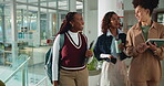 Talking, students and women with tech, college or smile for group assignment, collaboration or test. University, friends and planning for task in hallway, conversation and people with backpack