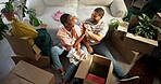 High five, couple and unpacking boxes in new house for mortgage success, relocation and teamwork. Laughing, black people and helping with unboxing clothes in first home for moving in, above and goals