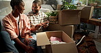 Real estate, couple and unpacking boxes in new house for moving in, property purchase and teamwork. Excited, black people and helping with unboxing clothes in first home for relocation or achievement