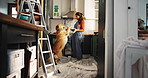 Painting, play and happy woman with dog for renovations, kitchen upgrade and maintenance. Labrador, hug and homeowner with excited pet animal in new home for diy, makeover and decoration decision