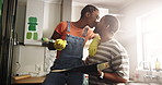 Smile, black couple painting and kiss in home for bonding, care and diy decoration. Renovation, man and woman with romance for remodeling, love and commitment with partner for marriage in kitchen