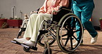 Legs, wheelchair and nurse in garden with patient at retirement village, push and support for mobility. People, caregiver and job with elderly person with disability, feet and help for rehabilitation