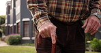 Outdoor, walking stick and old man with retirement, hands and weekend break. Closeup, pensioner and elderly person with disability, cane and nature with wellness and mobility support for arthritis