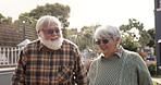 Talk, walk and happy old couple in yard with love, relationship and bonding at nursing home together. Outdoor, pensioner and elderly people in retirement to relax with care, support or conversation