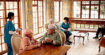 Nursing home, caregiver and senior people with conversation, support and wellness with retirement. Elderly group, pensioners or medical service with professional, discussion and healthcare with break