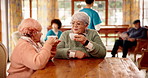 Nursing home, caregiver and old people with conversation, support and wellness with coffee. Elderly facility, pensioners or medical service with professional, discussion or healthcare with retirement