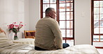 Back, depression and regret with senior man in retirement home for memories or nostalgia. Lonely, sad and thinking with unhappy elderly person in apartment for contemplation or mental health