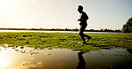 Running, athlete and man with sportswear, fitness and exercise routine for jog, outdoor and morning. Cardio, runner and person with speed for workout, nature and energy for wellness or training