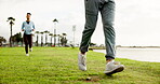 Legs, people and running for fitness at park for exercise, cardio training and morning routine. Feet, man and woman for sports workout, marathon practice and endurance challenge for wellness at lake