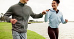 Running, fitness or happy couple in park for fist bump, teamwork or training in relationship. Athletes, lake and people greeting in nature for outdoor jog, motivation and support in cardio workout
