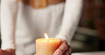 Candle, calm and hands of woman in home with zen, meditation or peace for chakra energy. Flame, spiritual health and female person with ritual for aura balance, wellness or relax in apartment.