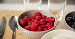 Food, diet and raspberries in bowl for health, nutrition and wellness in home kitchen. Fresh breakfast, natural fruits and closeup with organic meal for vegan benefits, antioxidants and dessert