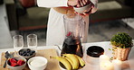 Raspberries, blender and hands of woman with smoothie in kitchen for liquid breakfast with diet or health. Nutrition, wellness and female person with fruit for beverage for morning meal in home.