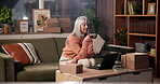 Mature woman, coffee and laptop in home with reading, smile and sales with dropshipping on sofa. Person, tea cup and drink with computer, ecommerce or remote work on couch for small business at house