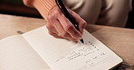 Hand, to do list and writing with person in living room of home for planning or reminder of tasks. Diary, journal or notebook with senior woman in apartment for agenda, checklist or event schedule