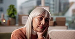 Thinking, tired  and sad with old woman in home for memory, reflection and mindset. Mental health, vision and nostalgia with elderly person in living room of apartment for depression and idea