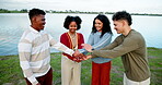 Huddle, lake and solidarity with friends outdoor together for motivation, support or unity. Smile. stack of hands and success with group of happy people in nature for bonding or team building