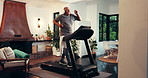 Senior man, music and exercise on treadmill for fitness, power walking or drinking water for health. Headphones, cardio machine and happy person in home for workout, audio or training in retirement