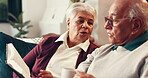 Elderly couple, talk and bible book for worship, spiritual faith and connection to God. Senior people, prayer and holy scripture with guidance, testament and religious belief in Jesus Christ at house