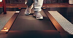 Treadmill, physiotherapy and walking with feet in home for activity, exercise or fitness routine. Legs, rehabilitation and wellness with person in apartment for action, cardio training or health