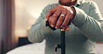 Hands, walking stick and senior man in house for healing, balance or arthritis recovery. Rehabilitation, wood cane and elderly male person with a disability for mobility aid, help or assistance.