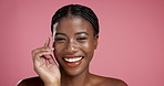 Skincare, hand and smile with face of black woman in studio for self care, dermatology and glow. Beauty, shine and hydration with person on pink background for collagen, treatment and cosmetics
