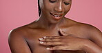 Skincare, chest and touch with black woman in studio for body care, dermatology and glow. Beauty, shine and grooming with person on pink background for collagen, hydration treatment and cosmetics