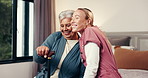 Healthcare, hug and caregiver with senior woman in home for consultation with good news for treatment. Medical checkup, conversation and nurse embracing female patient in bedroom for healing in house