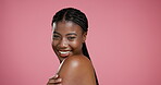 Beauty, shoulder and smile with face of black woman in studio for body care, dermatology or glow. Skincare, shine and hydration with person on pink background for collagen, treatment and mockup space